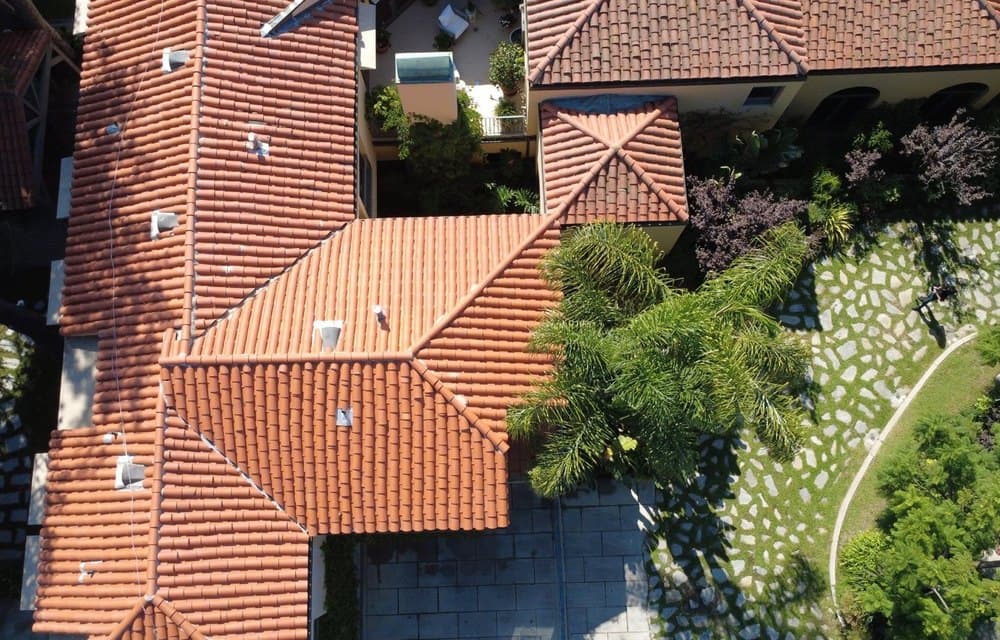 Aerial view of a hillside home with a FireShield system installed across its roof